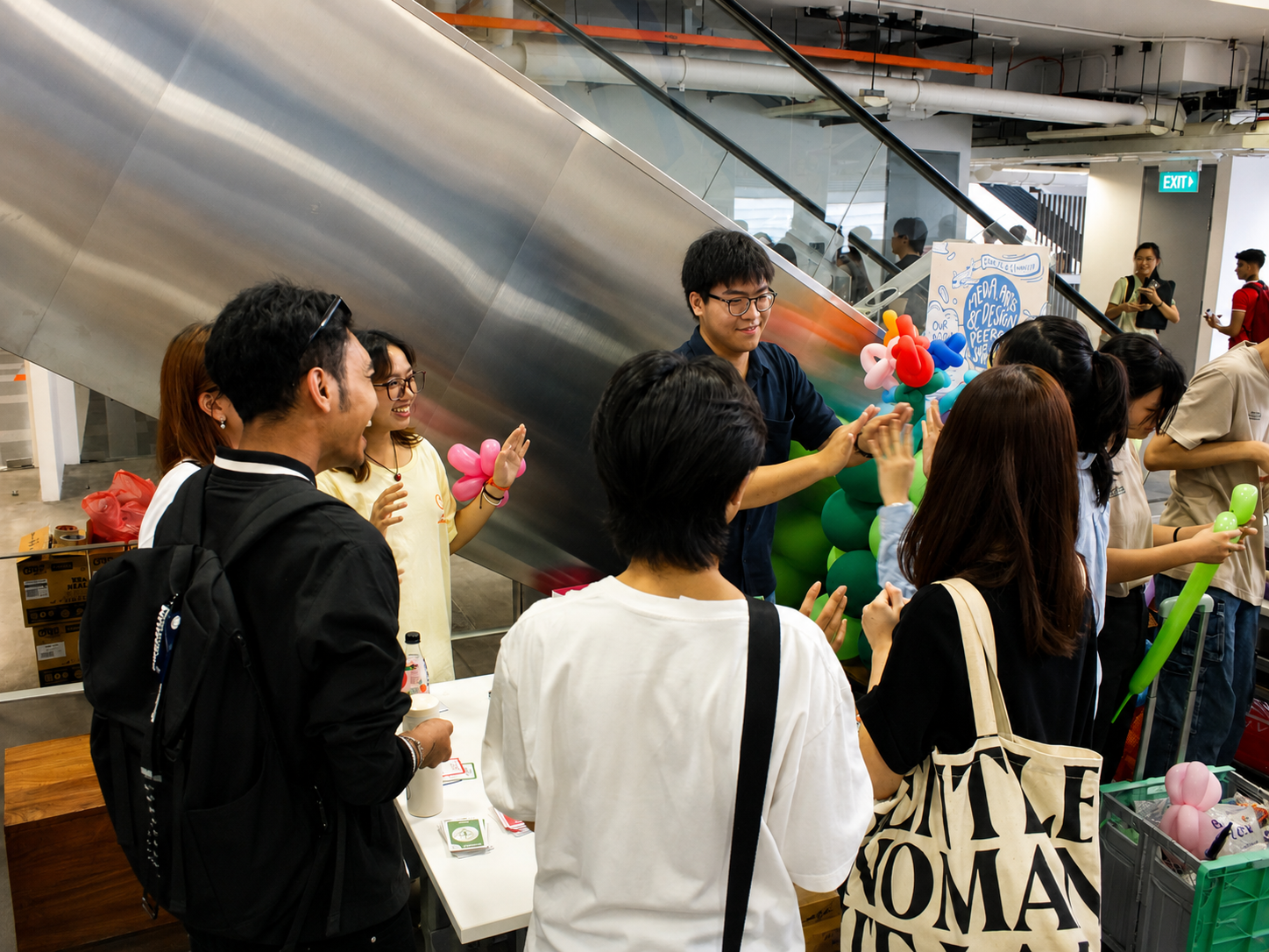 Students and visitors gathered around the Harmonics booth during a wellness showcase event.